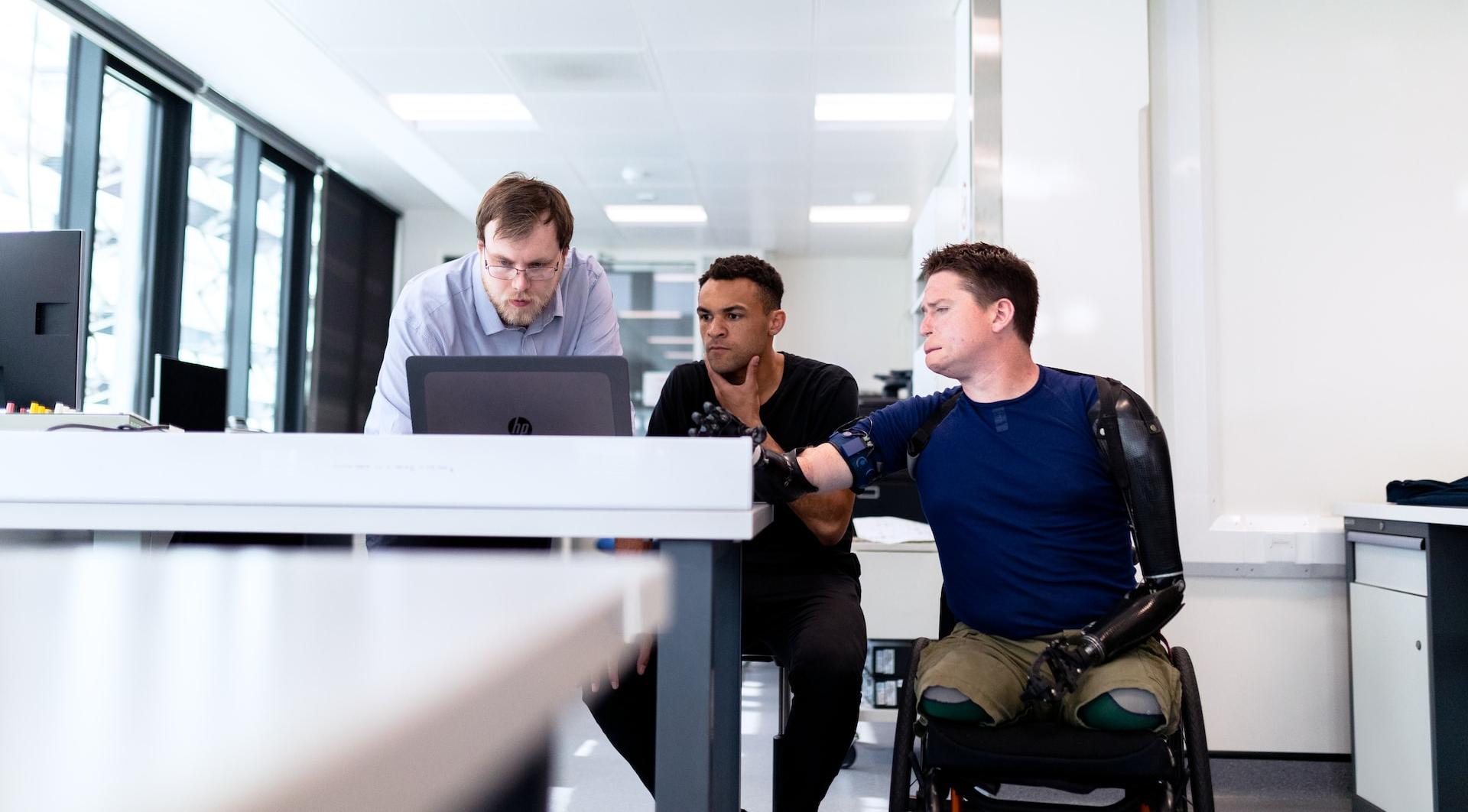 man in blue dress shirt sitting on black office rolling chair